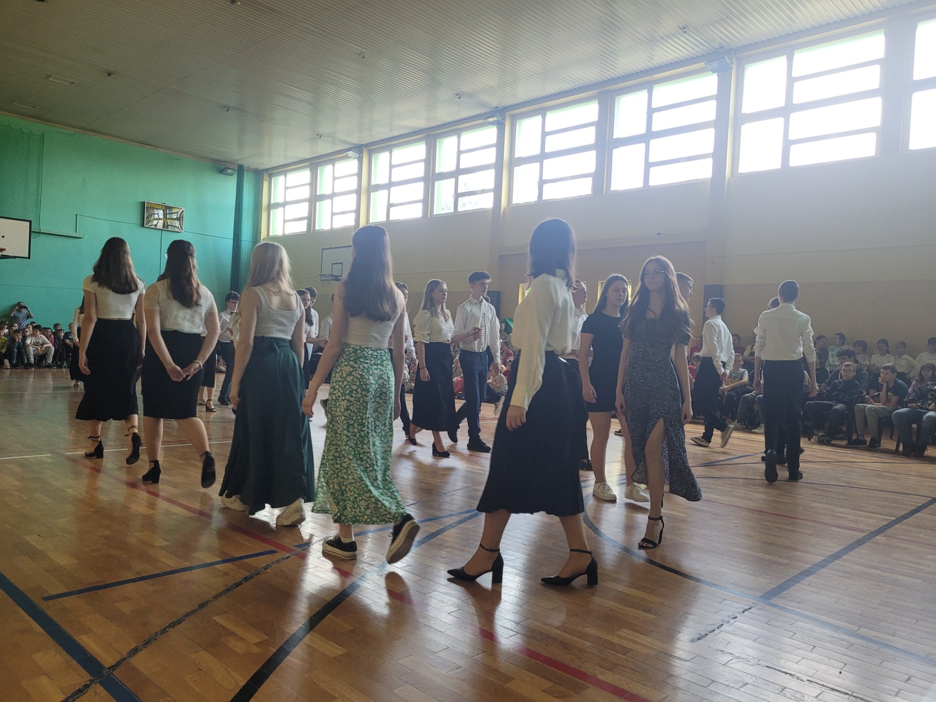 Uczniowie klas ósmych tańczą Poloneza.