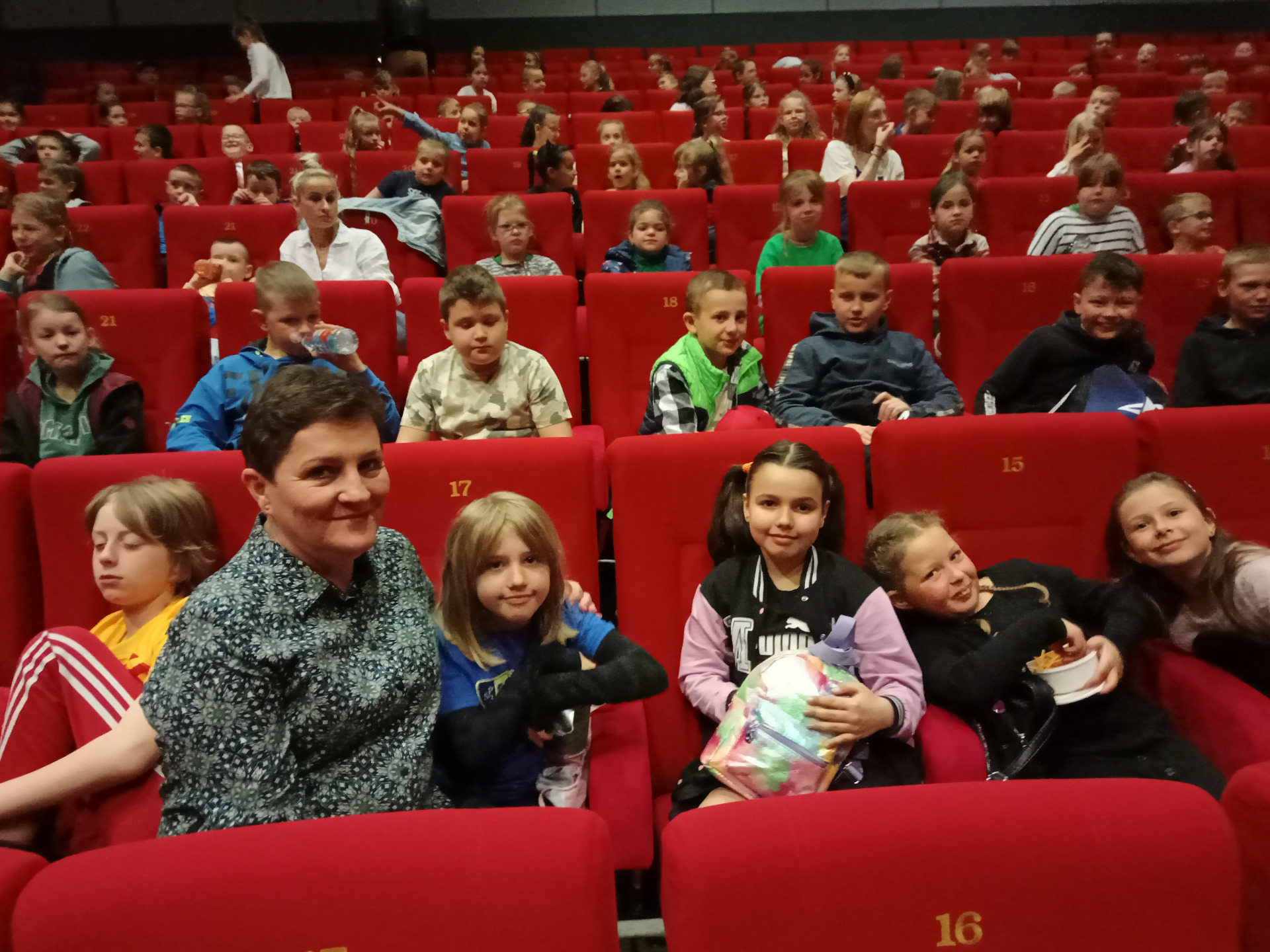12.05 2023 Na zdjęciu pani Ewa Gościniak ze swoimi wychowankami z klasy 2c podczas pobytu w kinie "Światowid" w Elblągu.